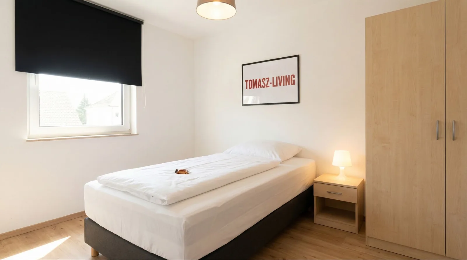 Einzelzimmer mit Bett und Kleiderschrank
